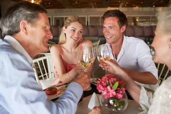 Group Of Friends Enjoying Meal In Restaurant