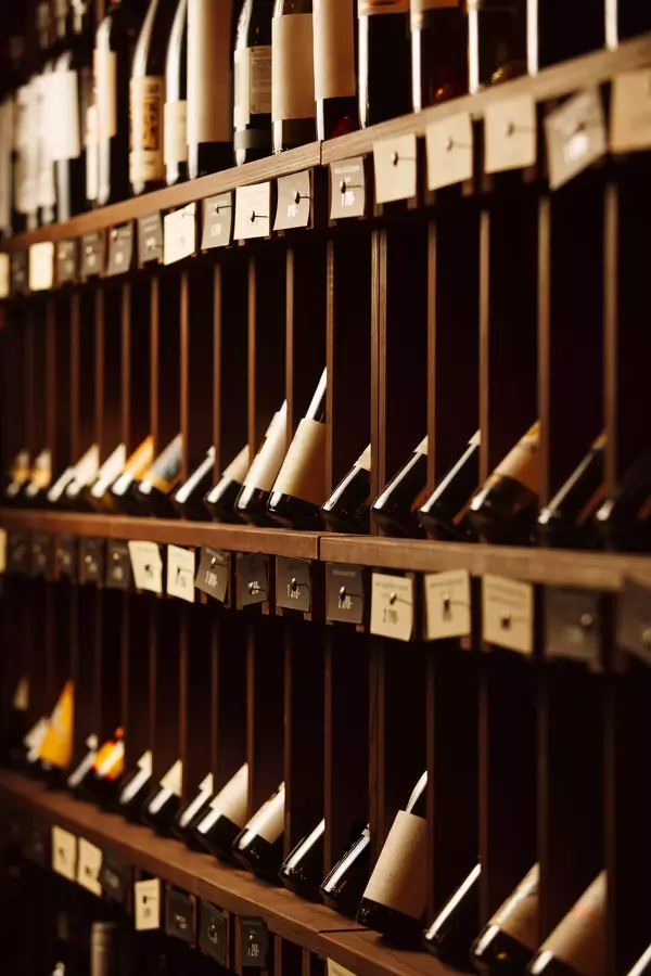 Winecellarwithelitedrinksonshelveswithwrittennames